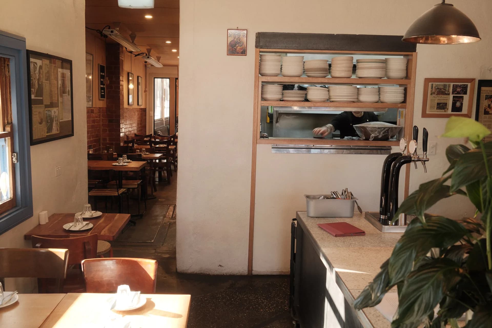 Alpha Ouzeri dining room and open kitchen pass