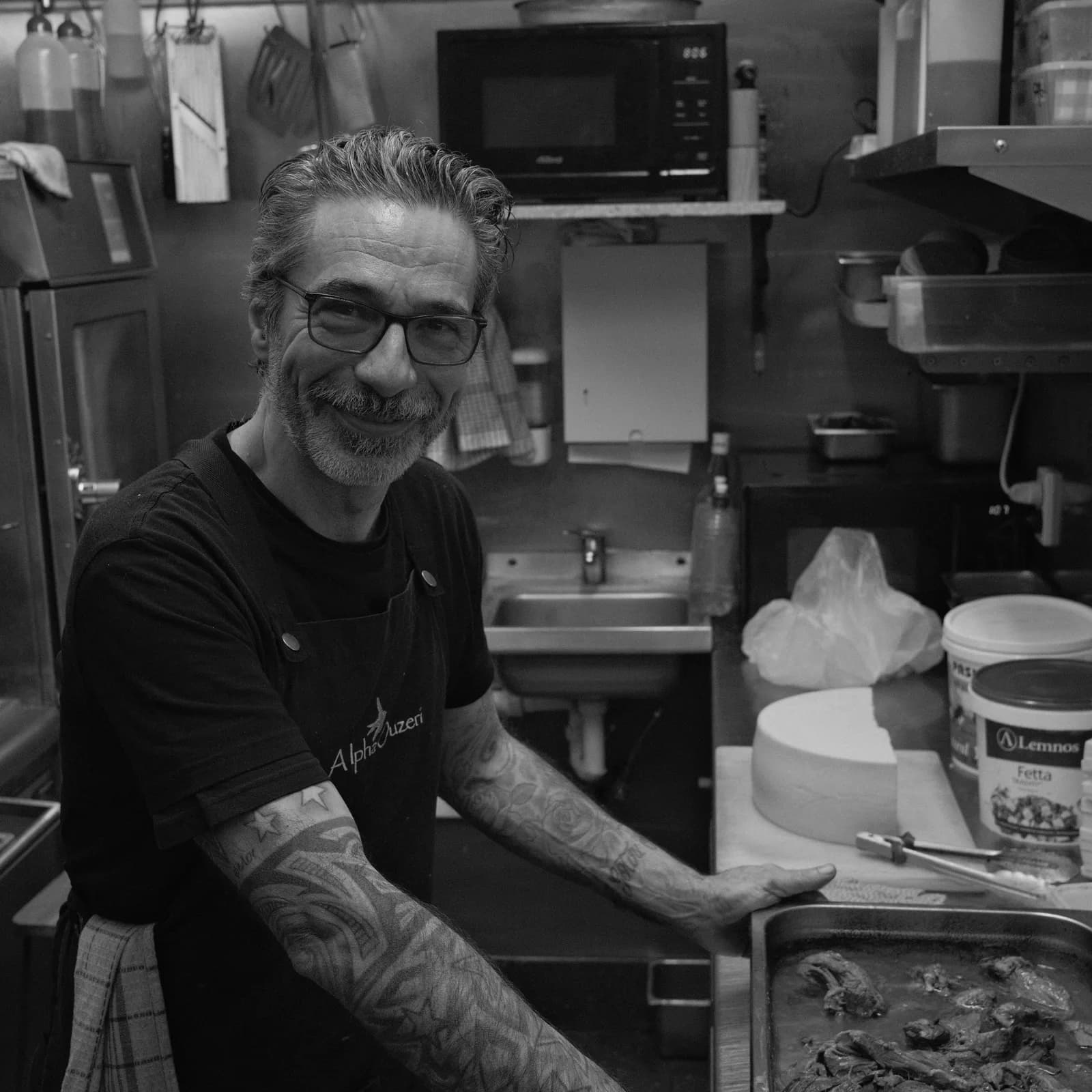 Alpha Ouzeri chef preparing food in the kitchen